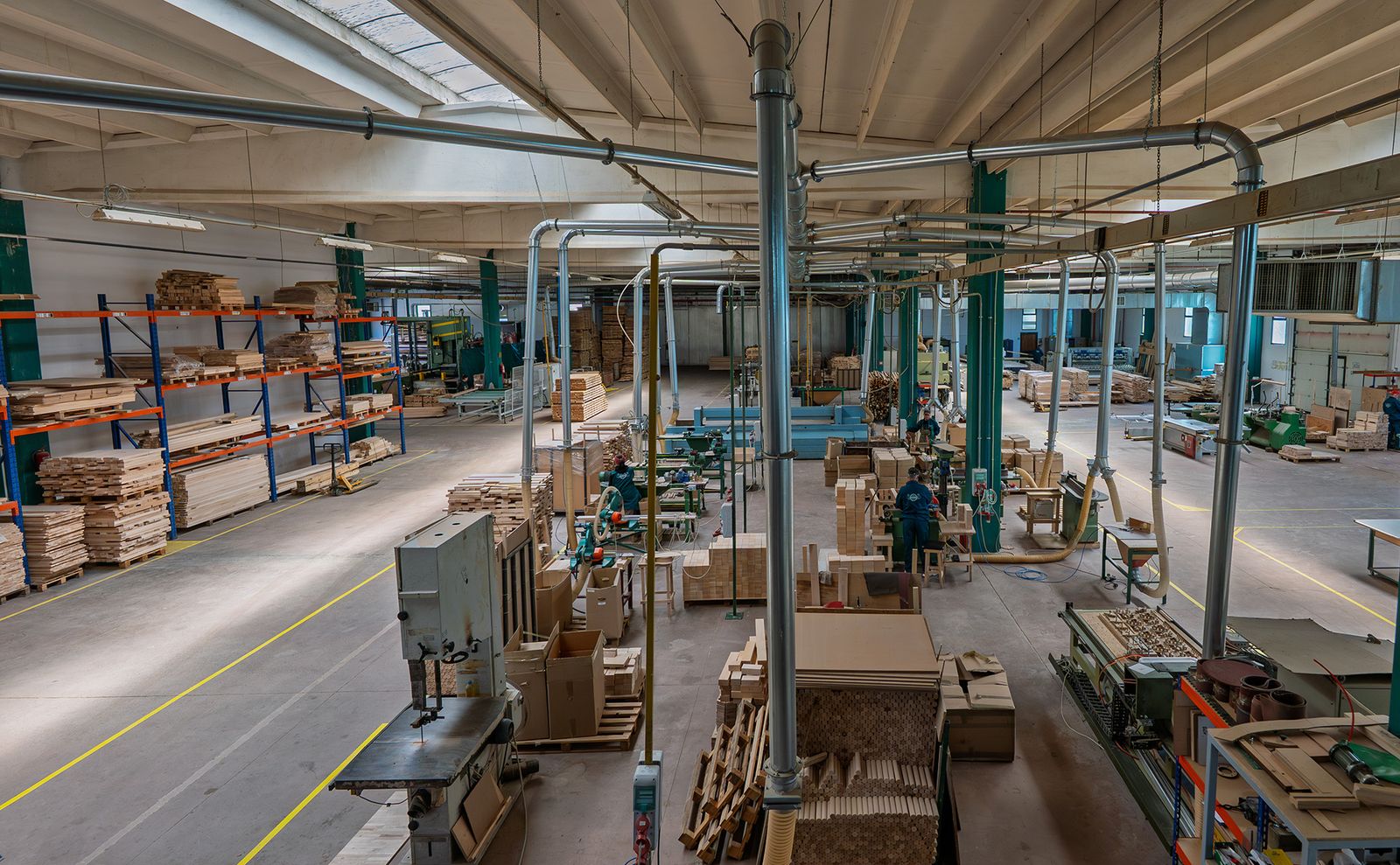 SARAL production hall from above, with woodworking machines and stacked hardwood parts