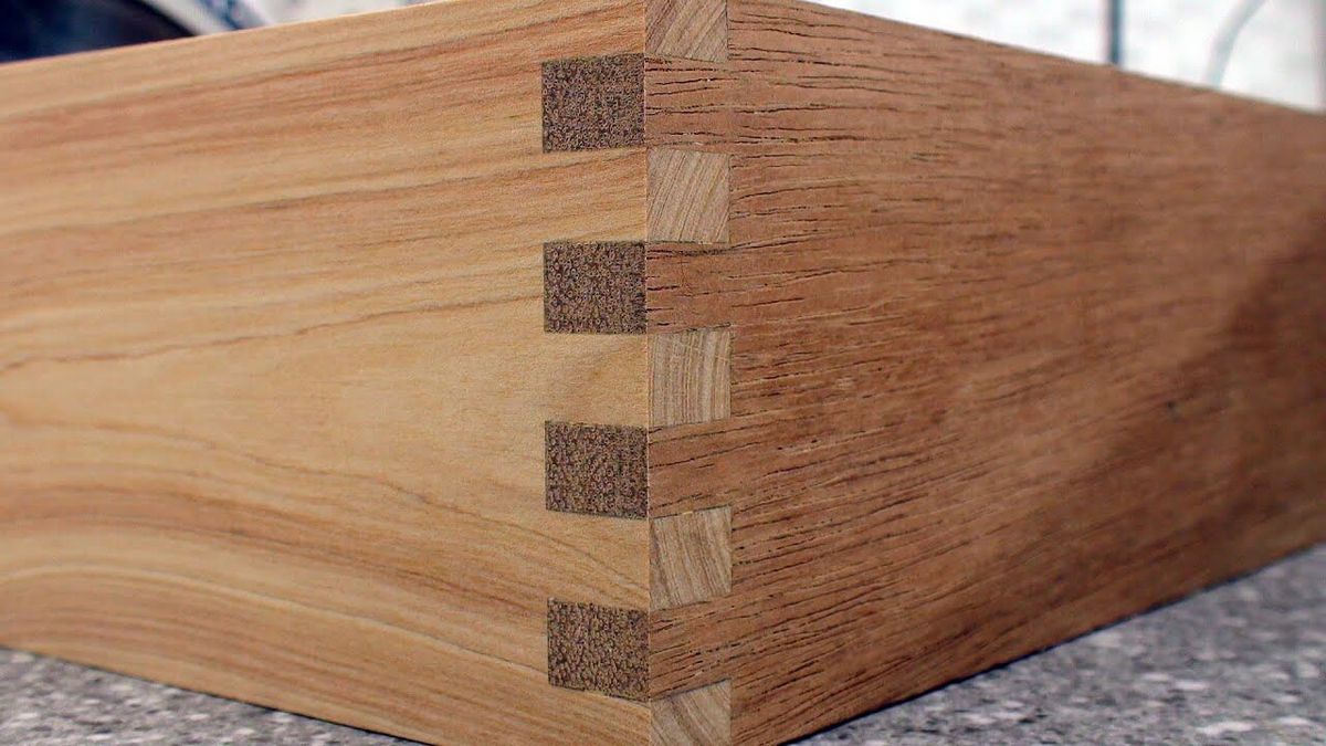 Box joints in a solid wood carcass showing end grain on the joint faces